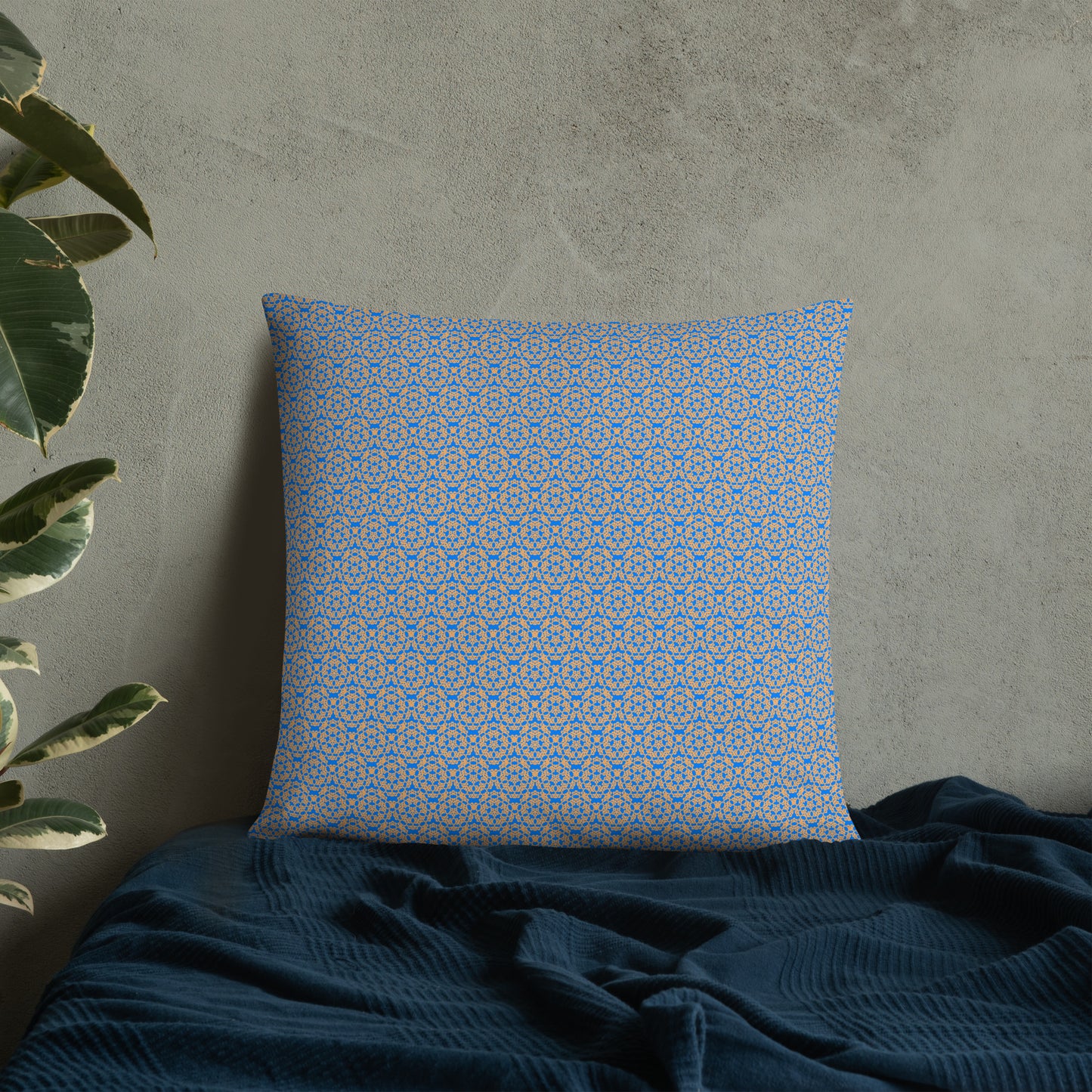 22″×22″ throw pillow with the 'Pentagon' blue and yellow geometric pattern on a bed.