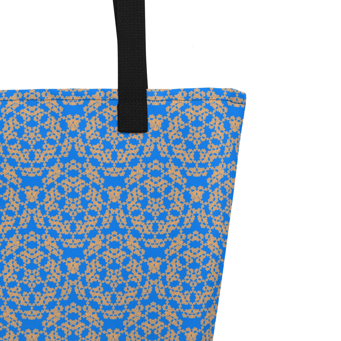 Close up of the strap stitching of the large tote bag with the 'Pentagon' blue and yellow fractal geometric pattern.