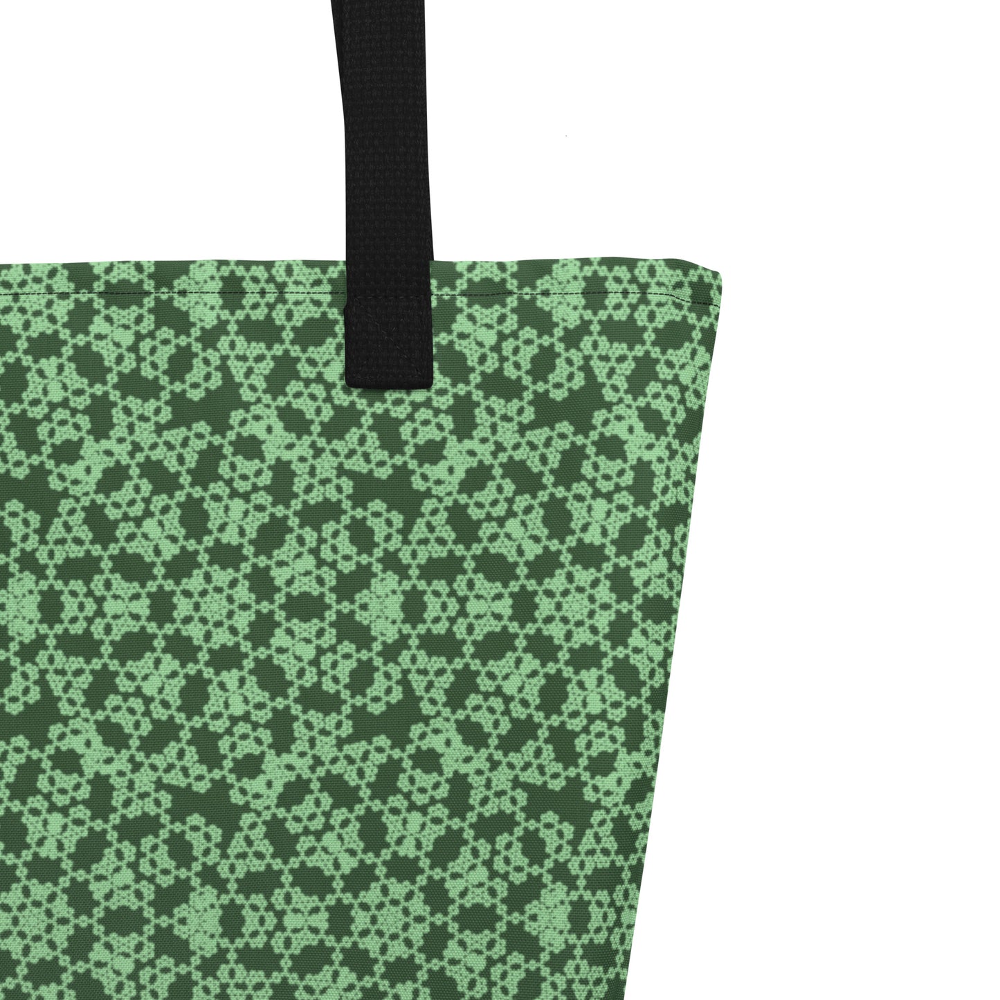 Close up of the strap stitching of the large tote bag with the 'Heptagon' green fractal geometric pattern.