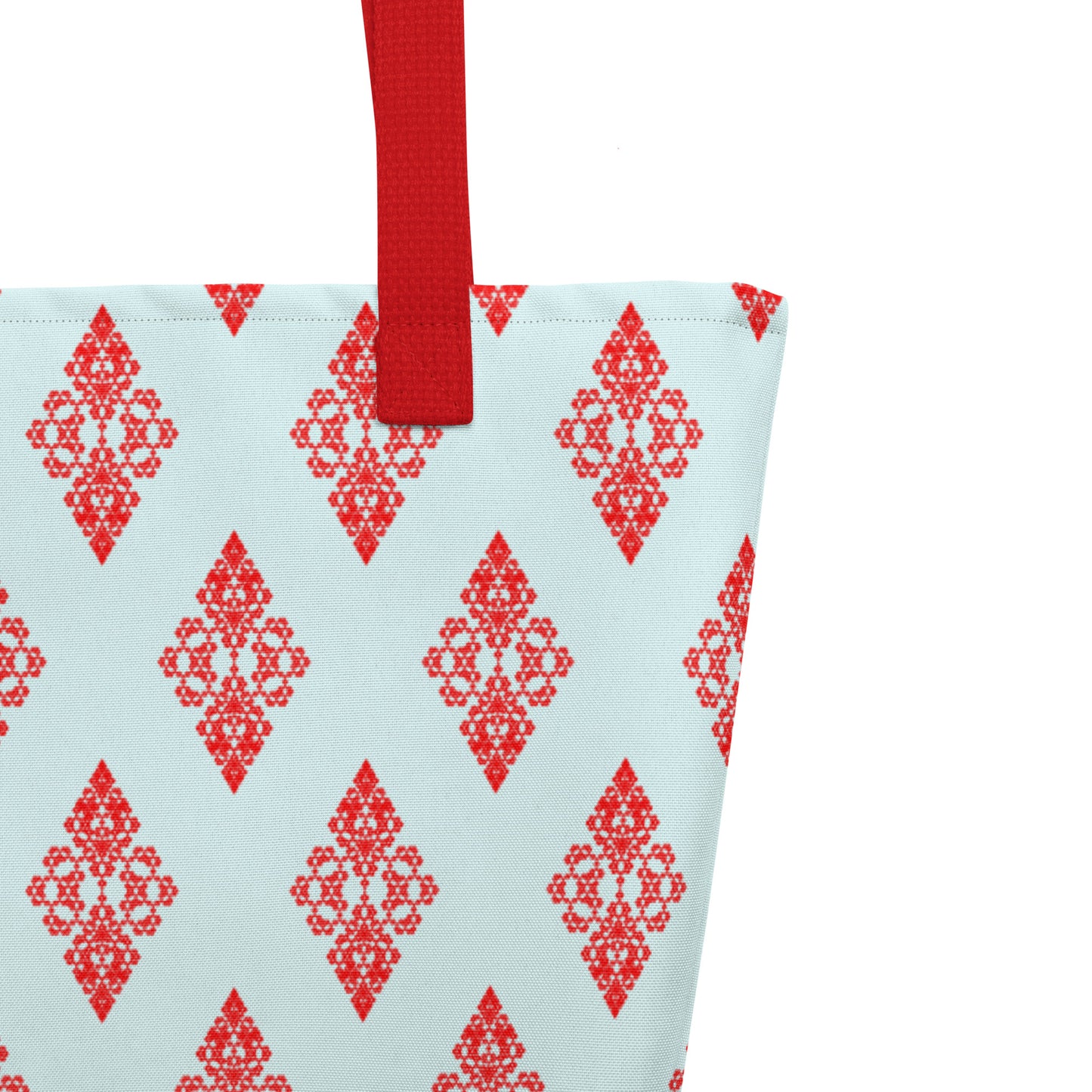 Close up of the strap stitching of the large tote bag with the 'Digon' sky blue and red fractal geometric pattern.