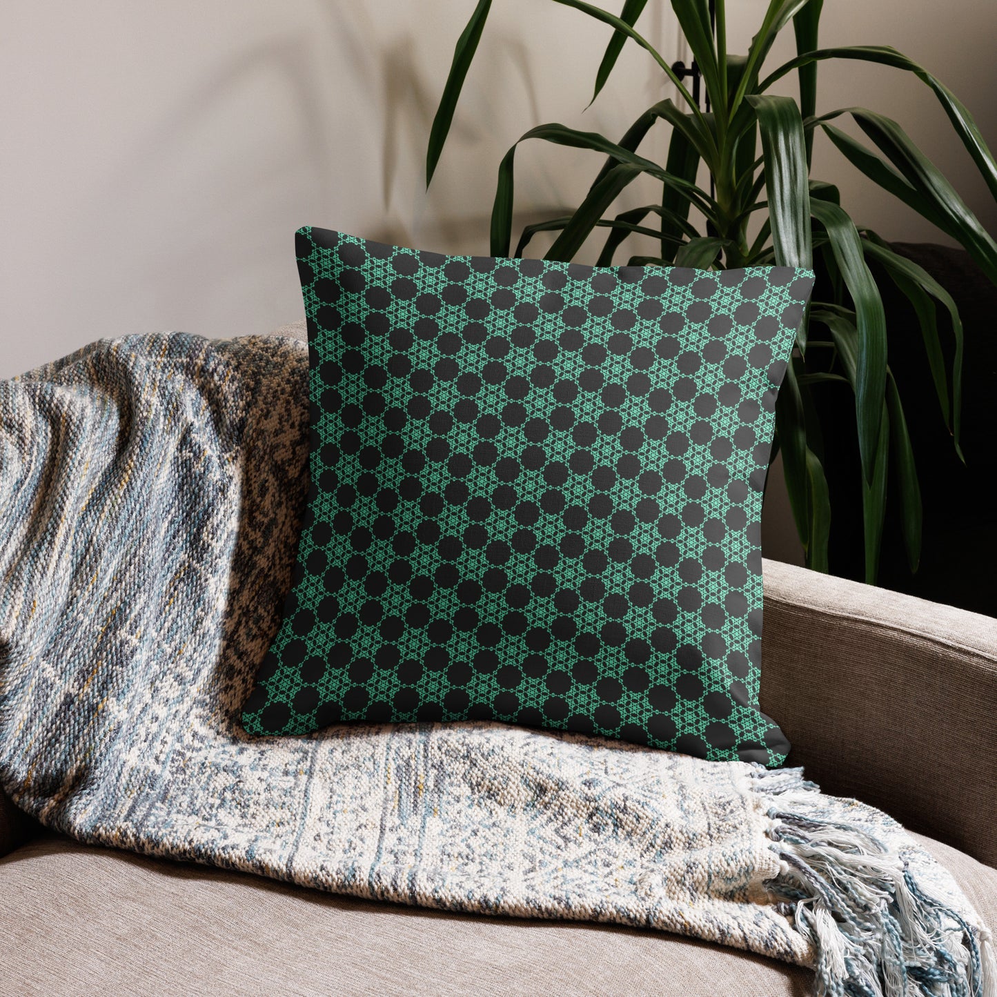 22″×22″ premium throw pillow with the 'Flowers Victory' charcoal and mint geometric pattern on a couch.