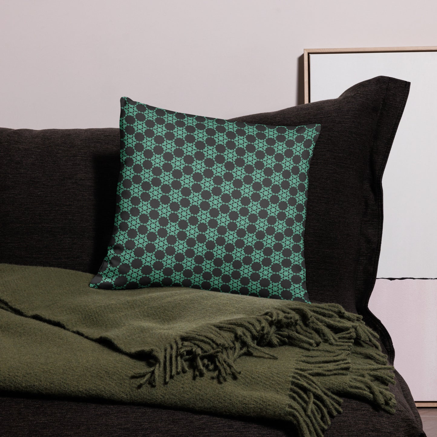 18″×18″ throw pillow with the 'Flowers Victory' charcoal and mint geometric pattern on a couch.