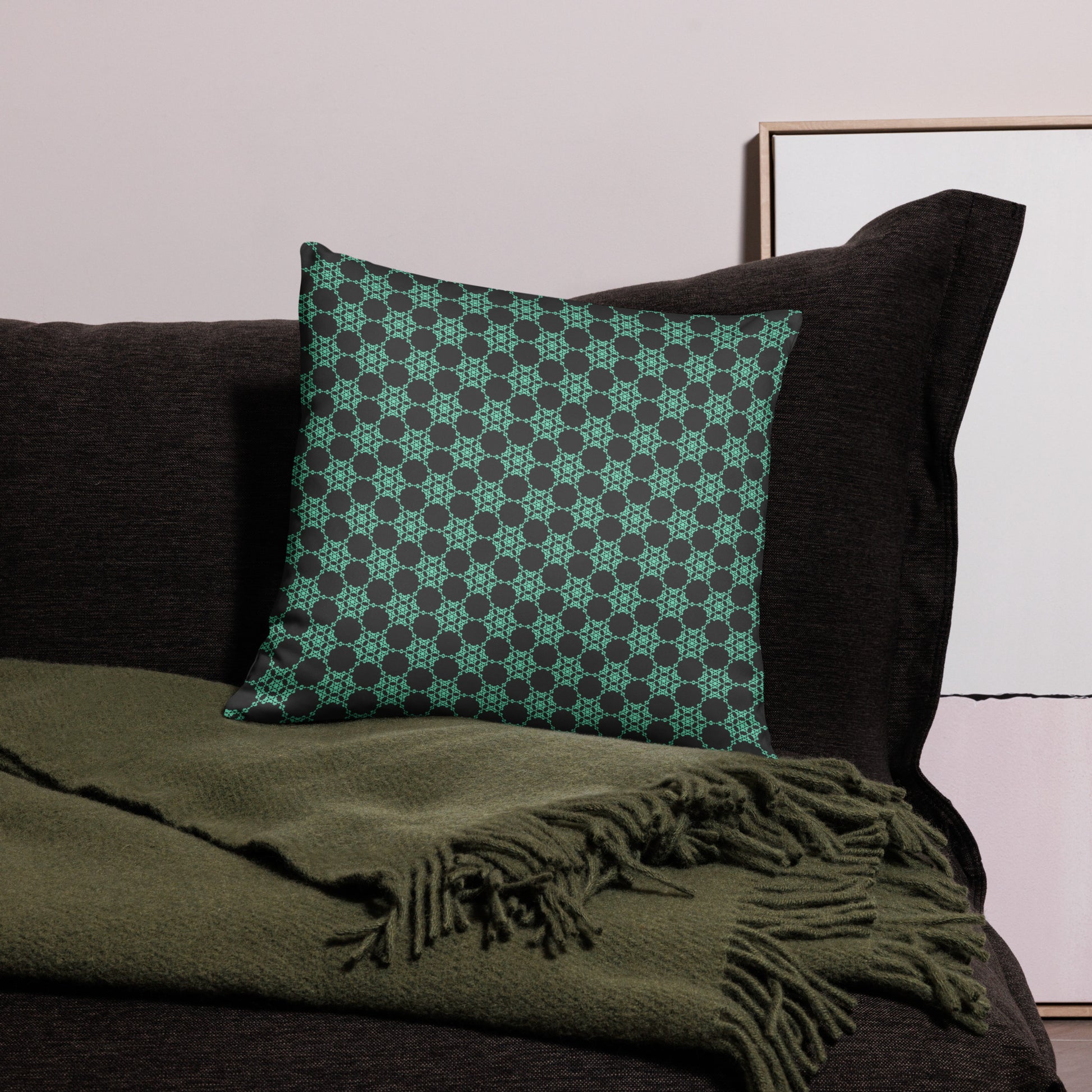 18″×18″ throw pillow with the 'Flowers Victory' charcoal and mint geometric pattern on a couch.