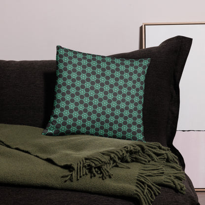 18″×18″ throw pillow with the 'Flowers Victory' charcoal and mint geometric pattern on a couch.