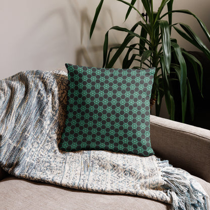 18″×18″ throw pillow with the 'Flowers Victory' charcoal and mint geometric pattern on a couch.