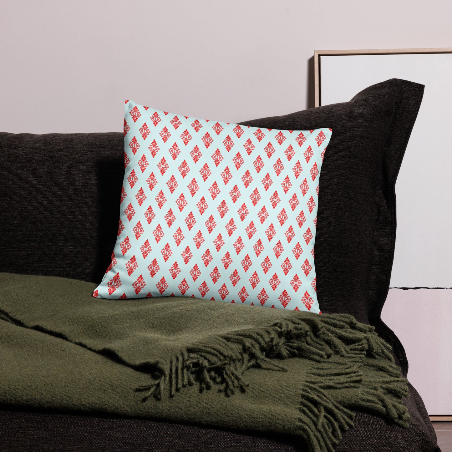 18″×18″ throw pillow with the 'Digon' sky blue and red geometric pattern on a couch.