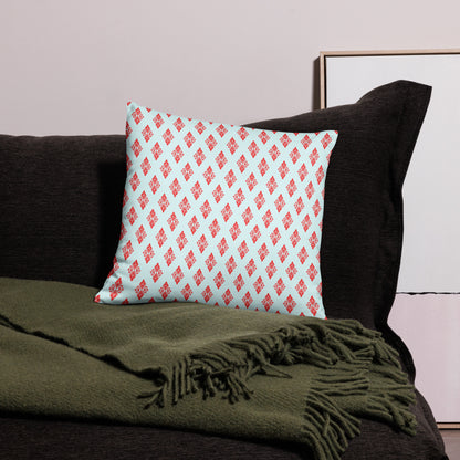 18″×18″ throw pillow with the 'Digon' sky blue and red geometric pattern on a couch.