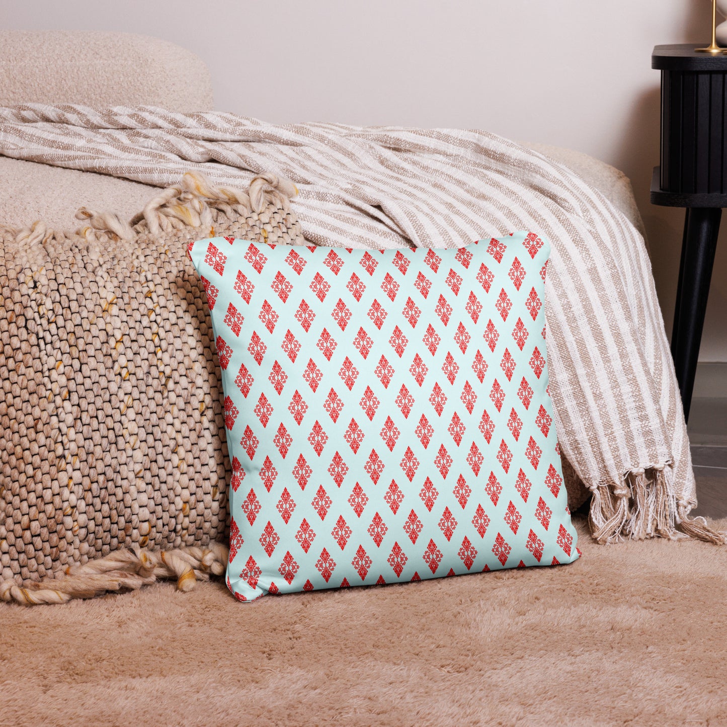 18″×18″ throw pillow with the 'Digon' sky blue and red geometric pattern on a couch.