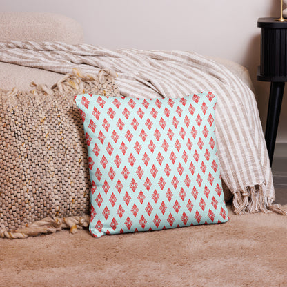 18″×18″ throw pillow with the 'Digon' sky blue and red geometric pattern on a couch.