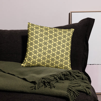 18″×18″ throw pillow with the 'Hexagon' yellow and black geometric pattern on a couch.