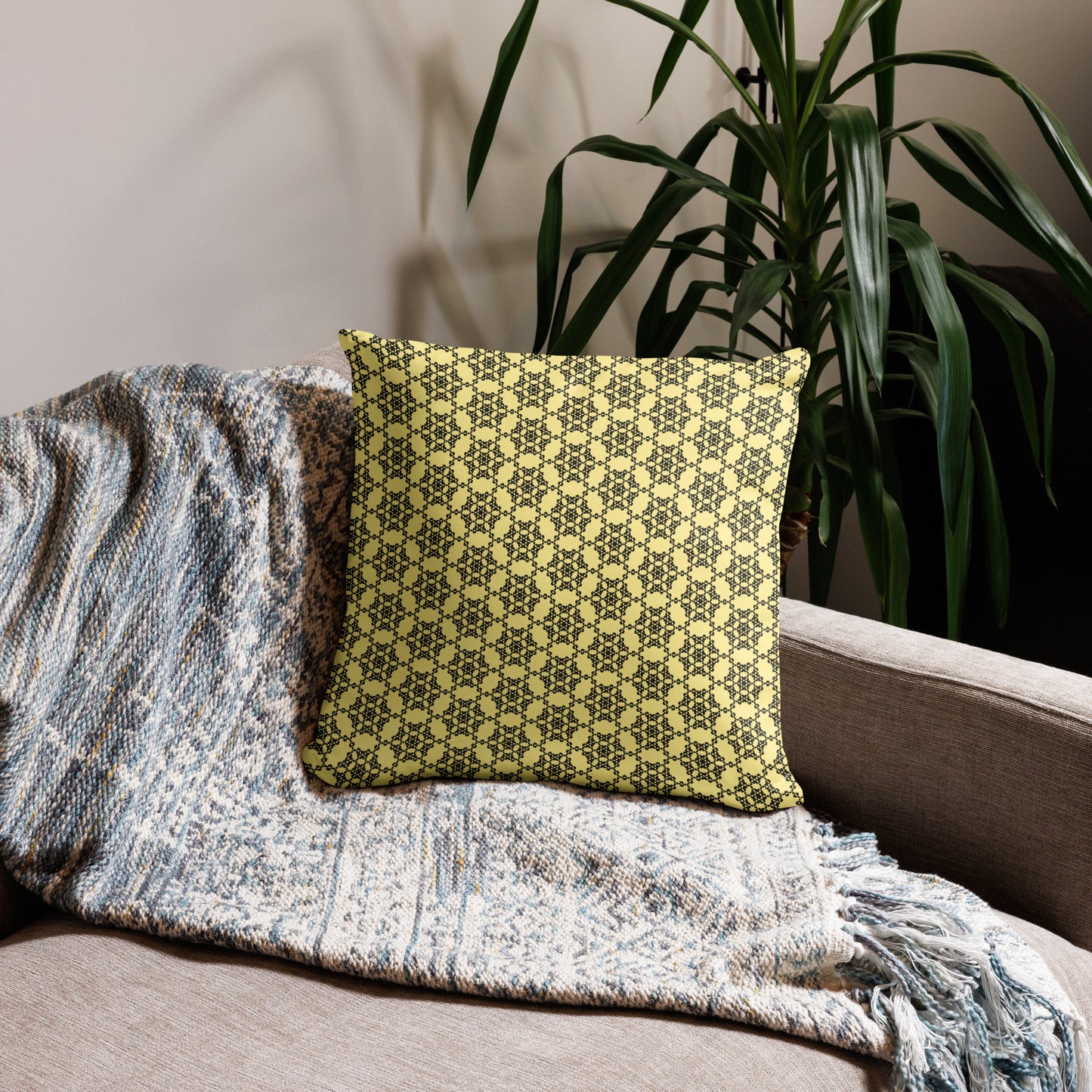 18″×18″ throw pillow with the 'Hexagon' yellow and black geometric pattern on a couch.