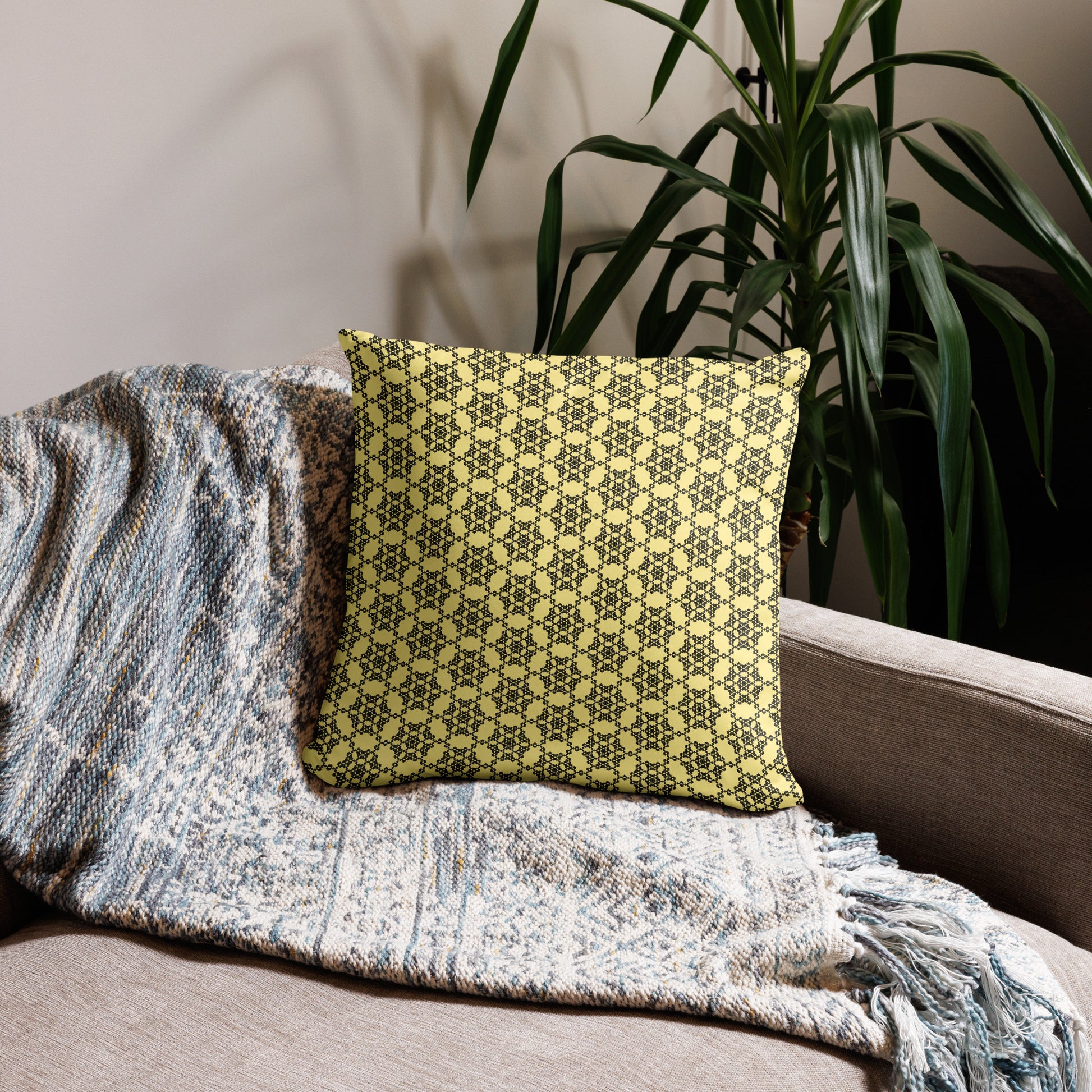 18″×18″ throw pillow with the 'Hexagon' yellow and black geometric pattern on a couch.