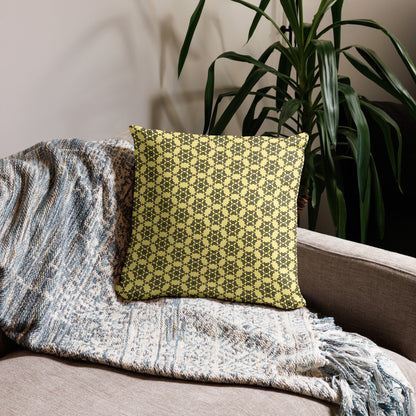 18″×18″ throw pillow with the 'Hexagon' yellow and black geometric pattern on a couch.