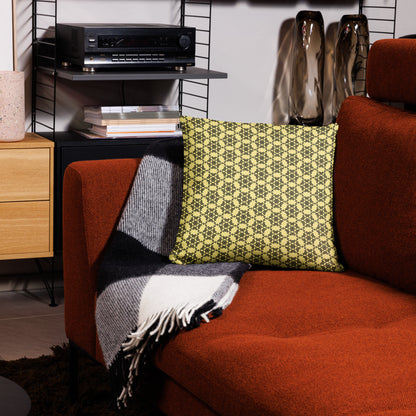 18″×18″ throw pillow with the 'Hexagon' yellow and black geometric pattern on a couch.
