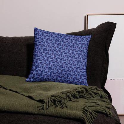 18″×18″ throw pillow with the 'Trigon' navy and blue geometric pattern on a couch.