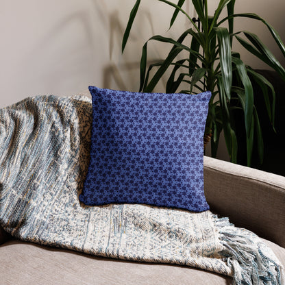 18″×18″ throw pillow with the 'Trigon' navy and blue geometric pattern on a couch.