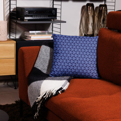 18″×18″ throw pillow with the 'Trigon' navy and blue geometric pattern on a couch.