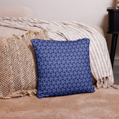 18″×18″ throw pillow with the 'Trigon' navy and blue geometric pattern on a couch.
