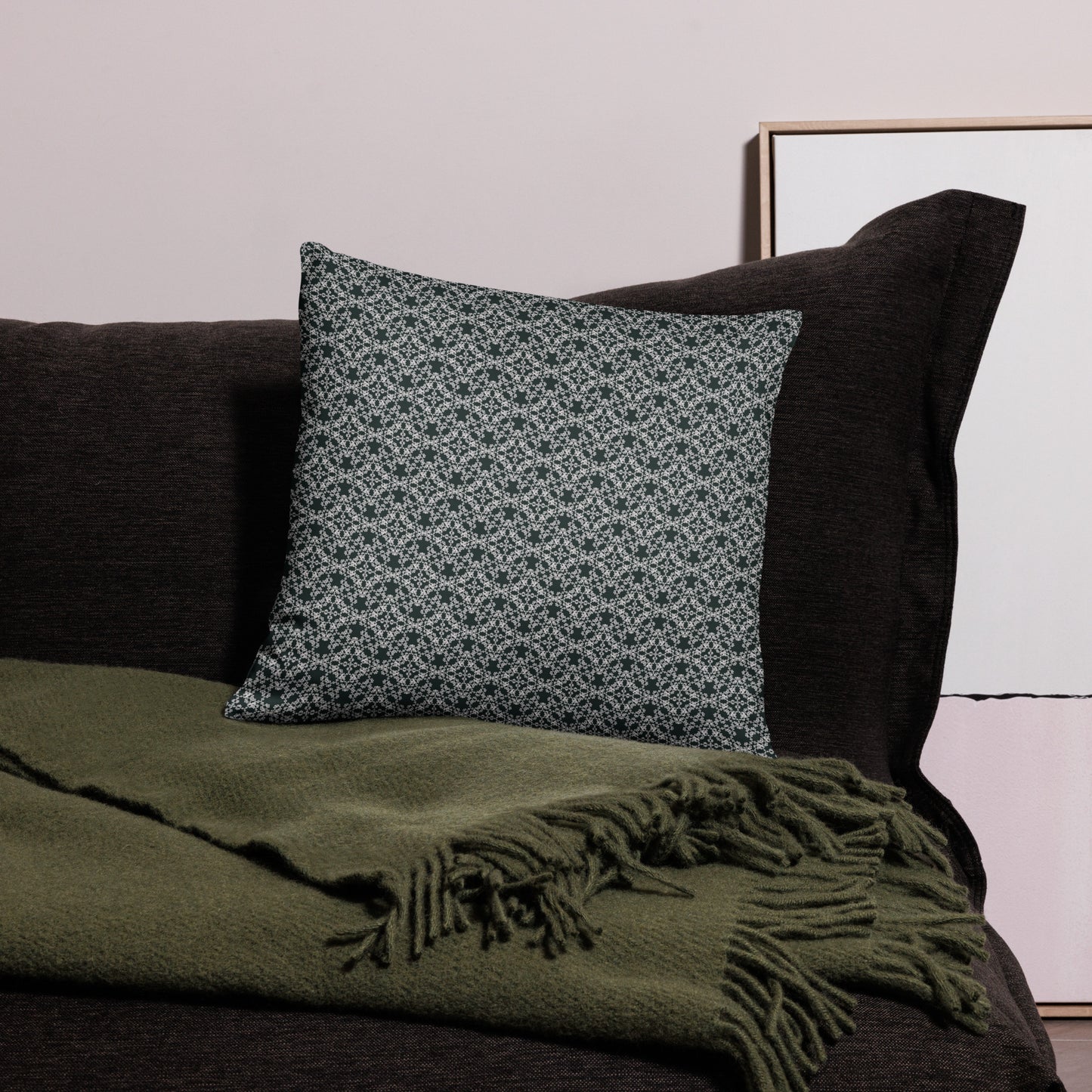 18″×18″ throw pillow with the 'Tetragon' charcoal and white geometric pattern on a couch.