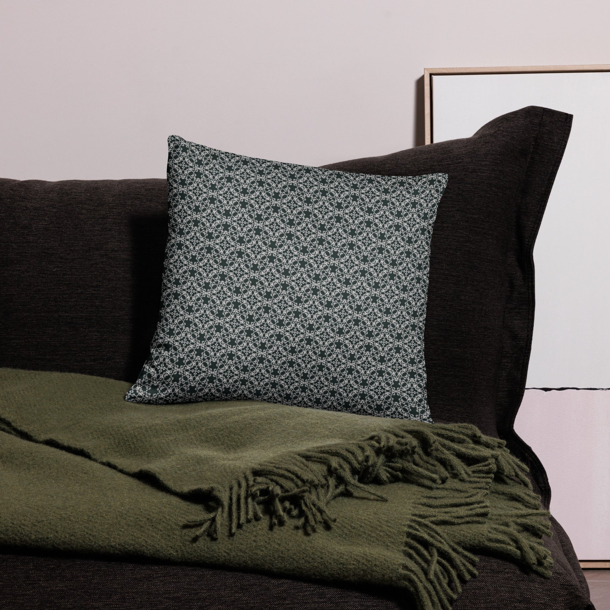 18″×18″ throw pillow with the 'Tetragon' charcoal and white geometric pattern on a couch.