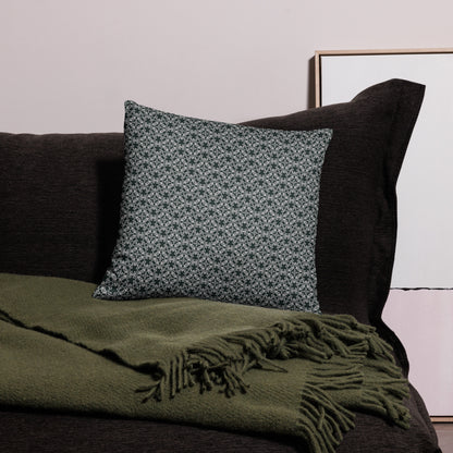 18″×18″ throw pillow with the 'Tetragon' charcoal and white geometric pattern on a couch.