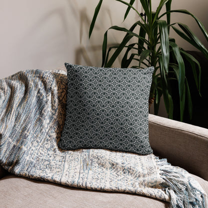 18″×18″ throw pillow with the 'Tetragon' charcoal and white geometric pattern on a couch.