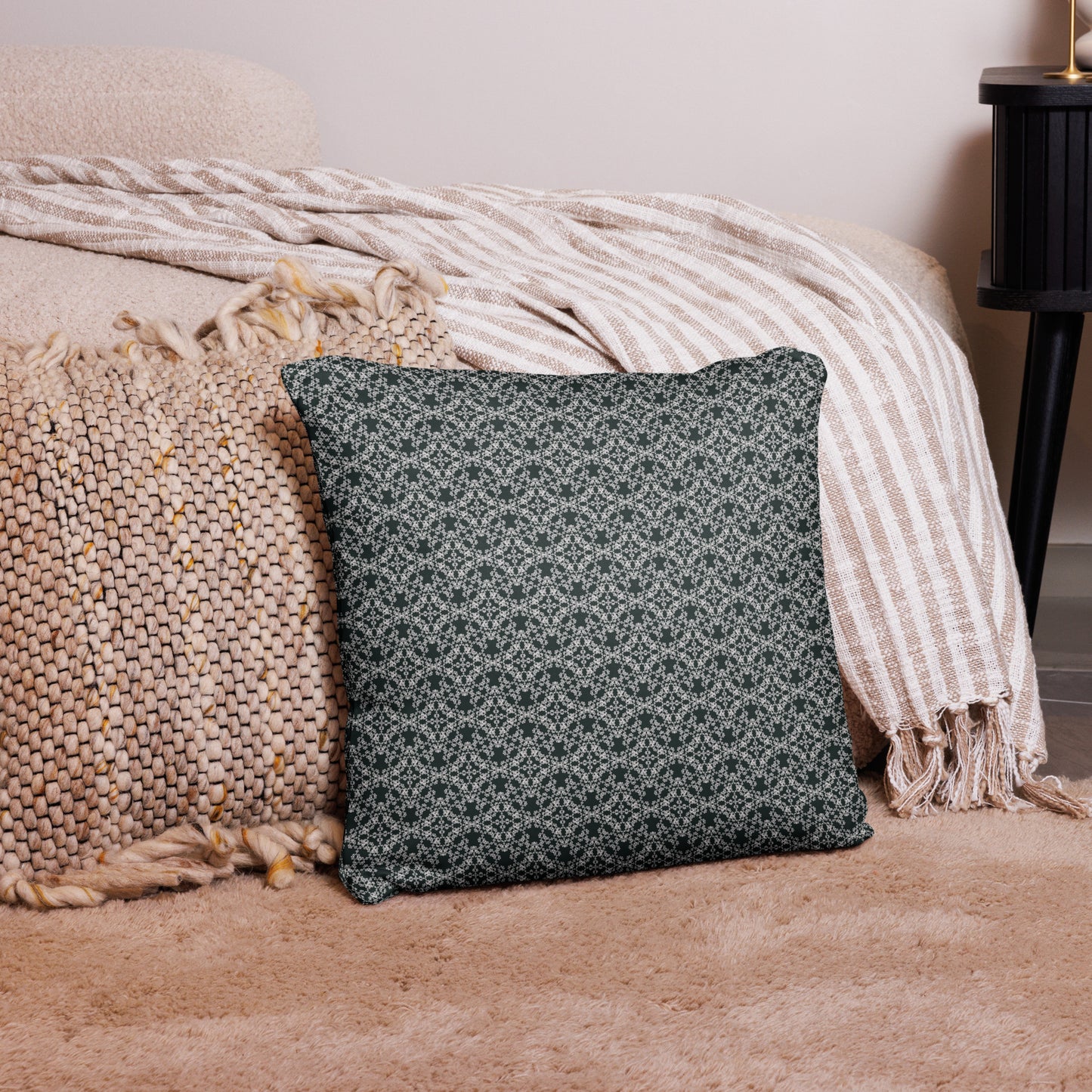 18″×18″ throw pillow with the 'Tetragon' charcoal and white geometric pattern on a couch.