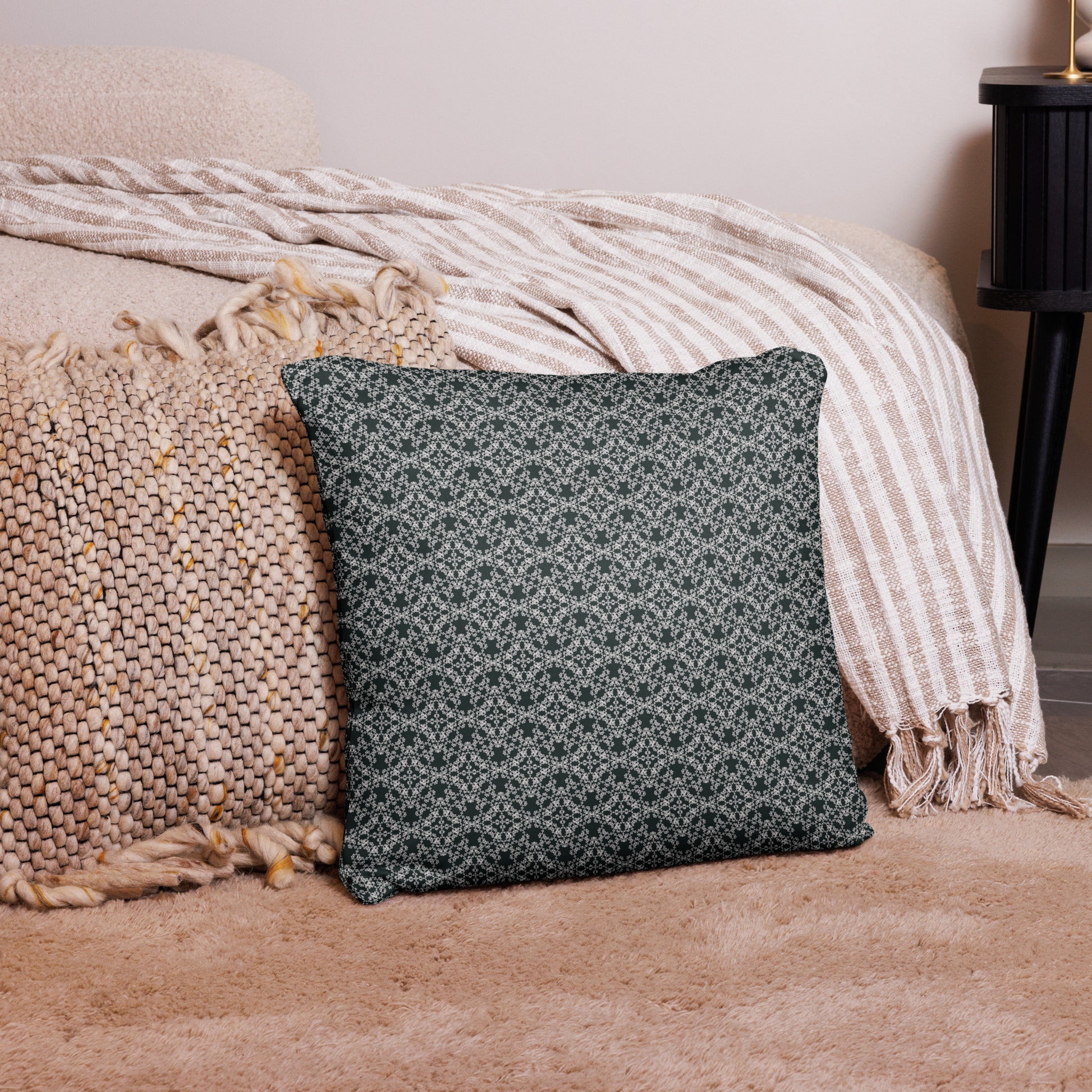 18″×18″ throw pillow with the 'Tetragon' charcoal and white geometric pattern on a couch.