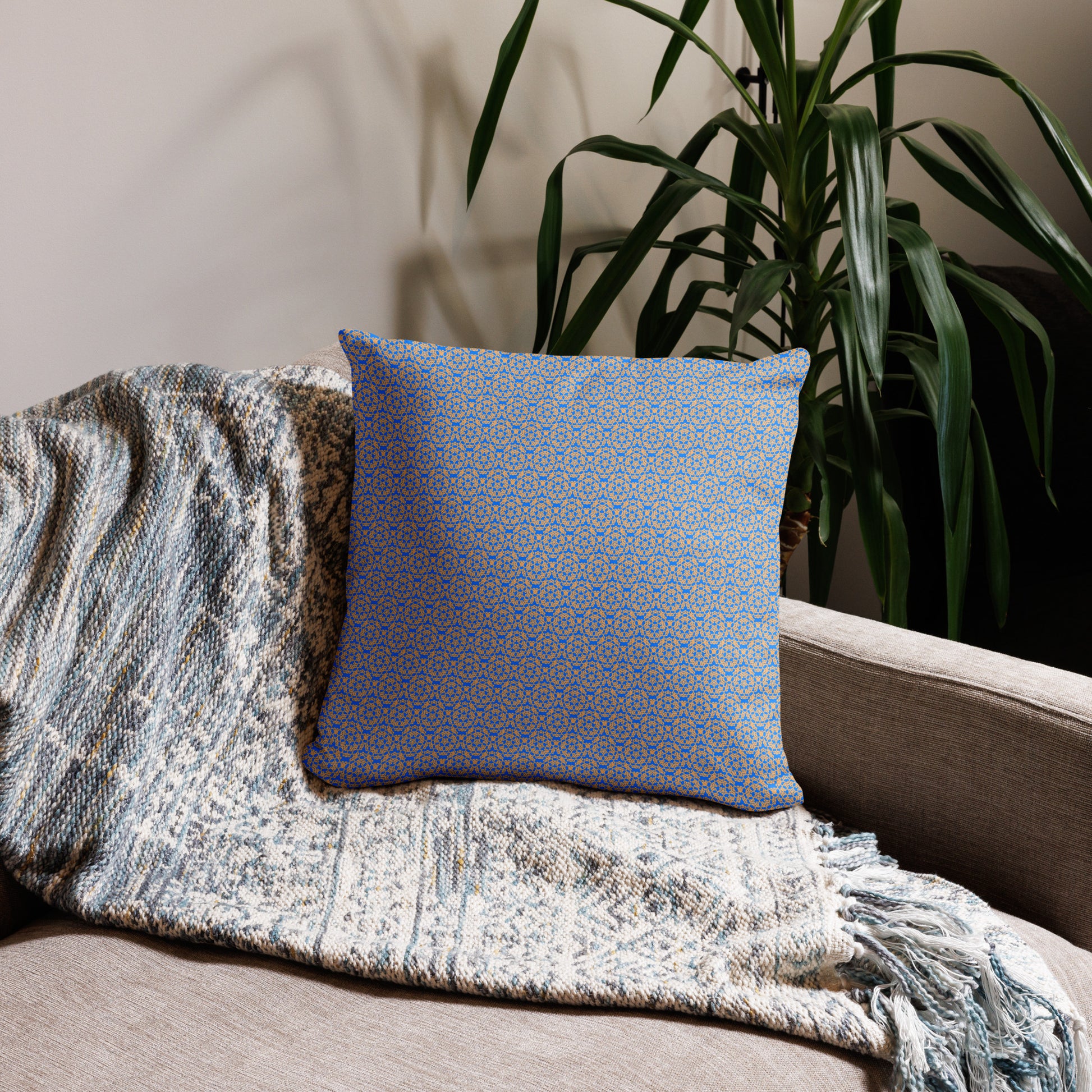18″×18″ throw pillow with the 'Pentagon' blue and yellow geometric pattern on a couch.
