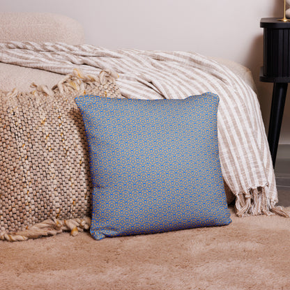 18″×18″ throw pillow with the 'Pentagon' blue and yellow geometric pattern on a couch.