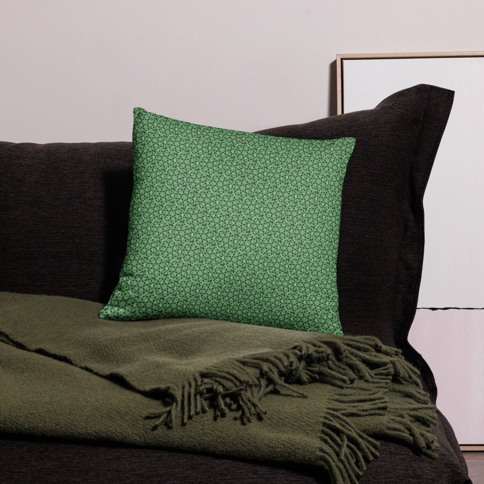 18″×18″ throw pillow with the 'Heptagon' green geometric pattern on a couch.