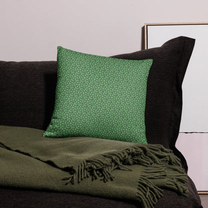 18″×18″ throw pillow with the 'Heptagon' green geometric pattern on a couch.