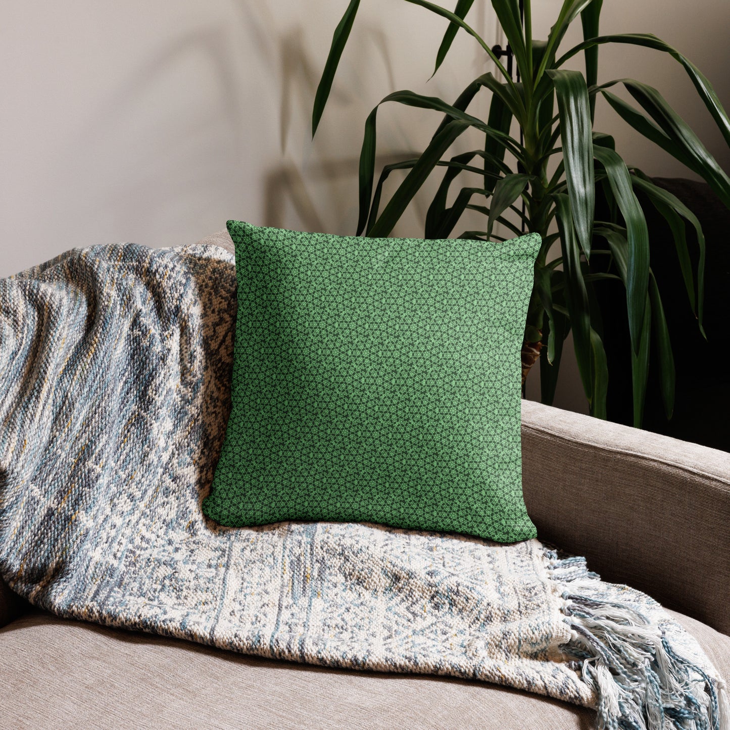 18″×18″ throw pillow with the 'Heptagon' green geometric pattern on a couch.