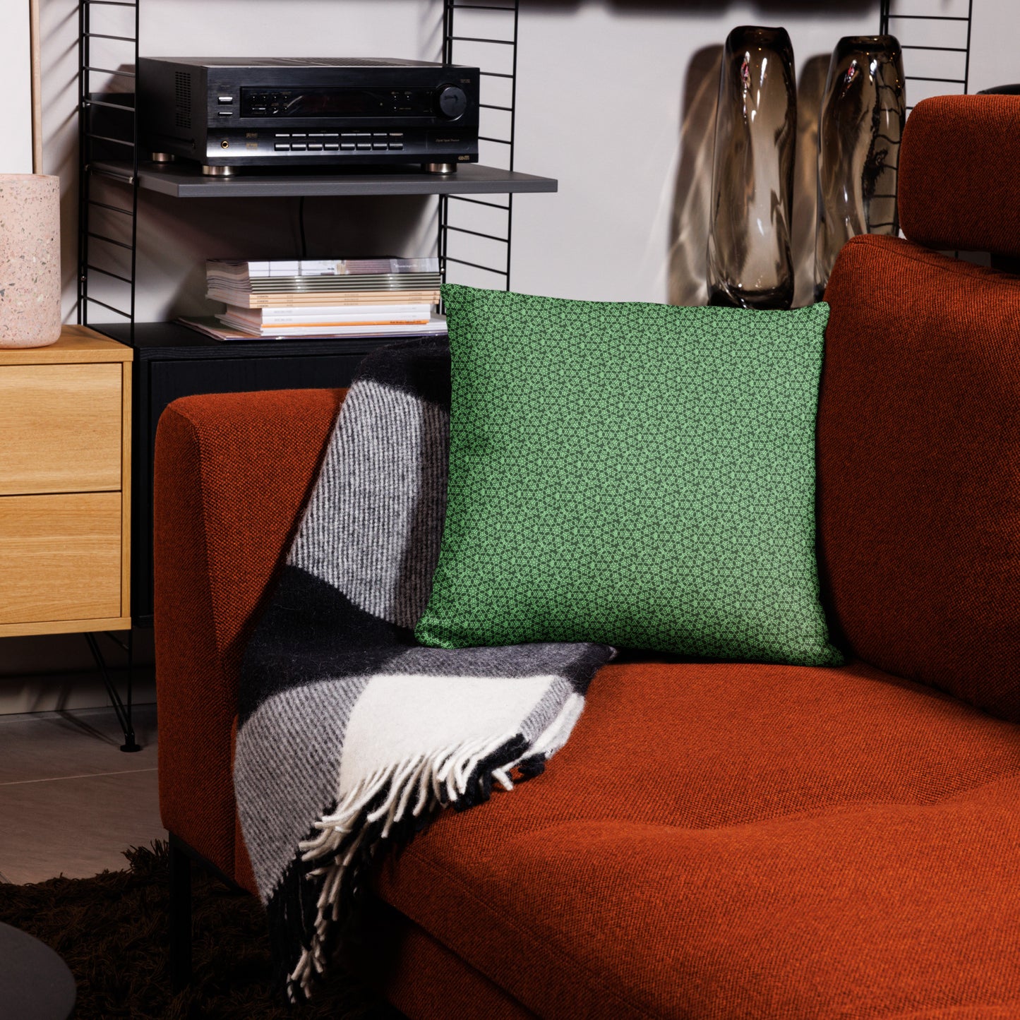 18″×18″ throw pillow with the 'Heptagon' green geometric pattern on a couch.
