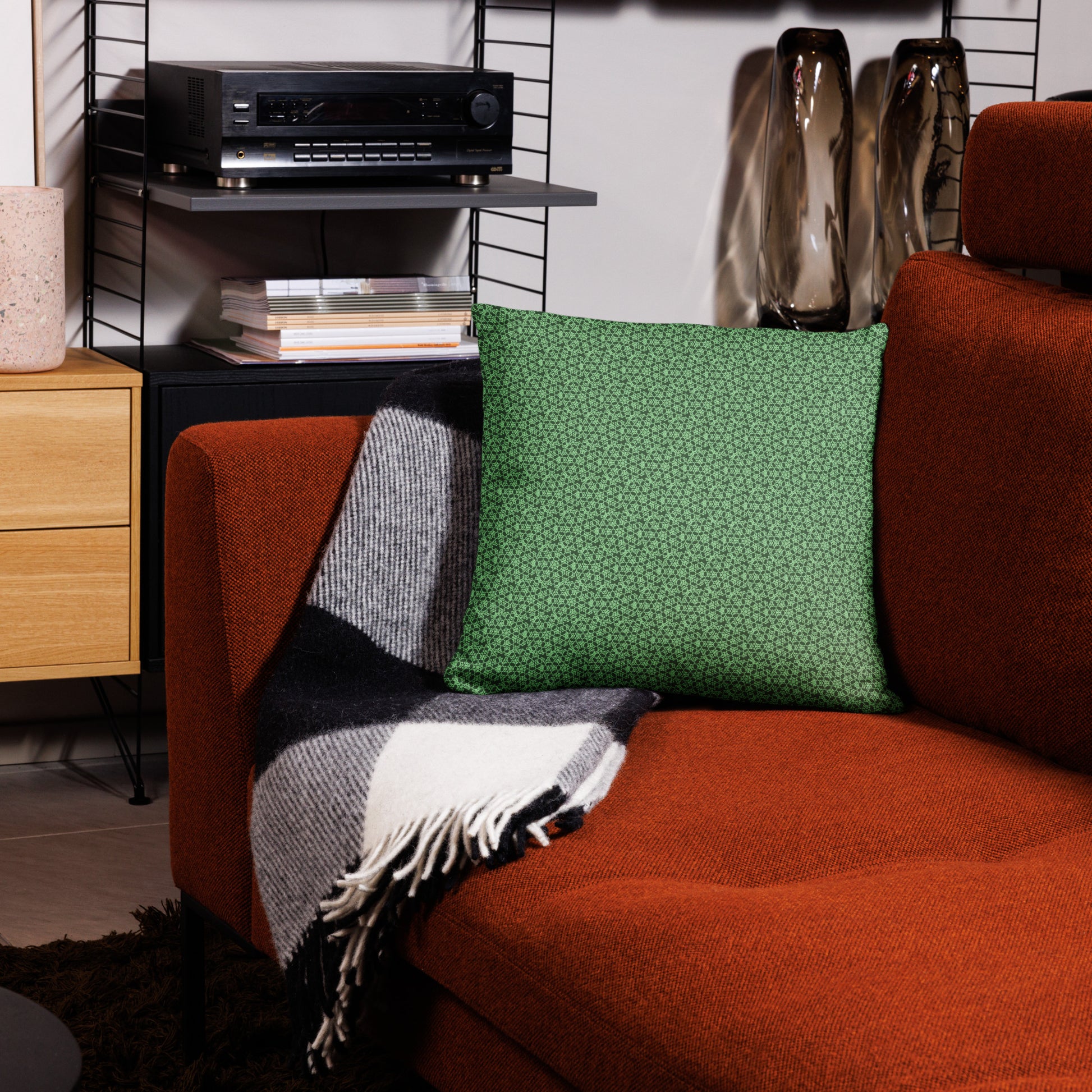 18″×18″ throw pillow with the 'Heptagon' green geometric pattern on a couch.