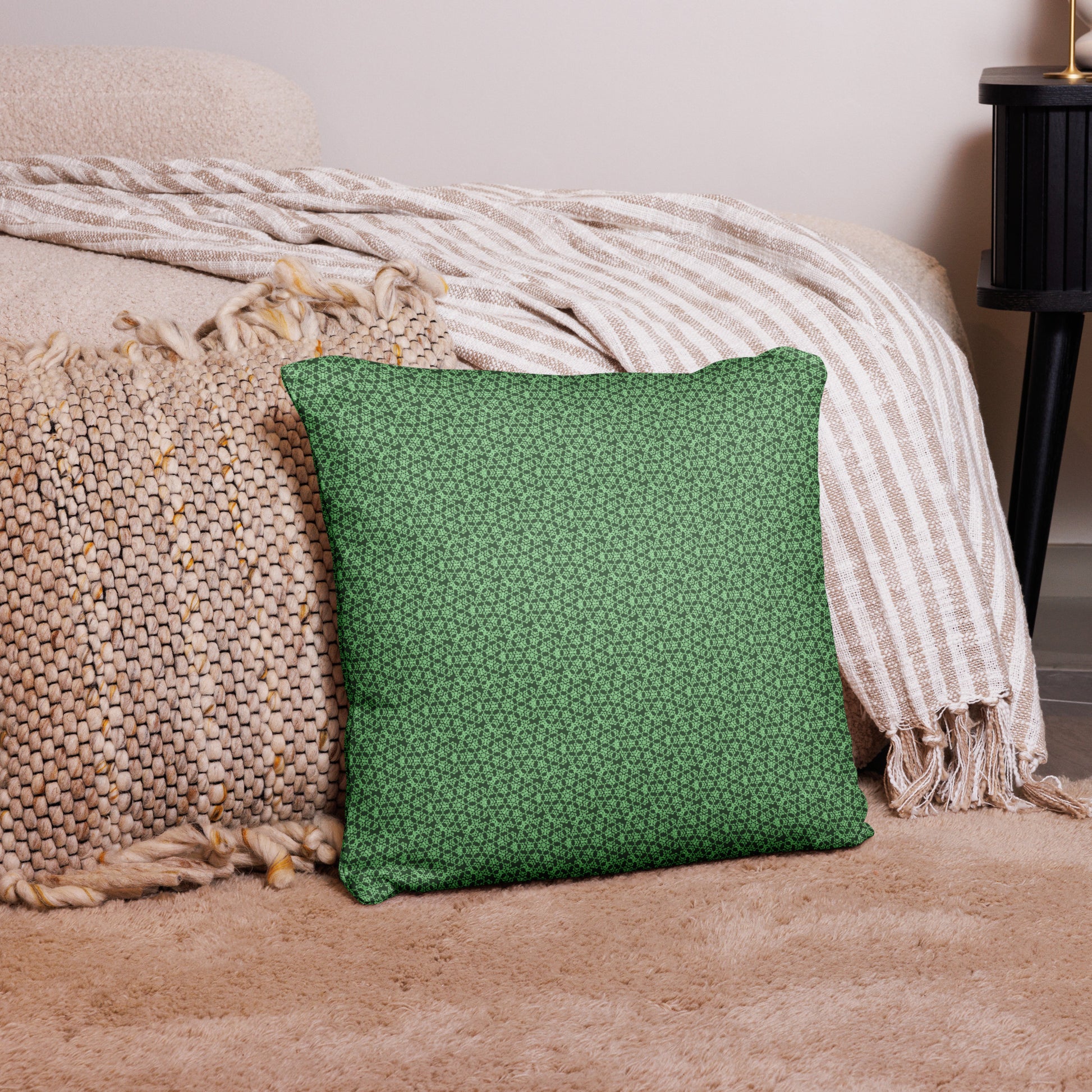 18″×18″ throw pillow with the 'Heptagon' green geometric pattern on a couch.