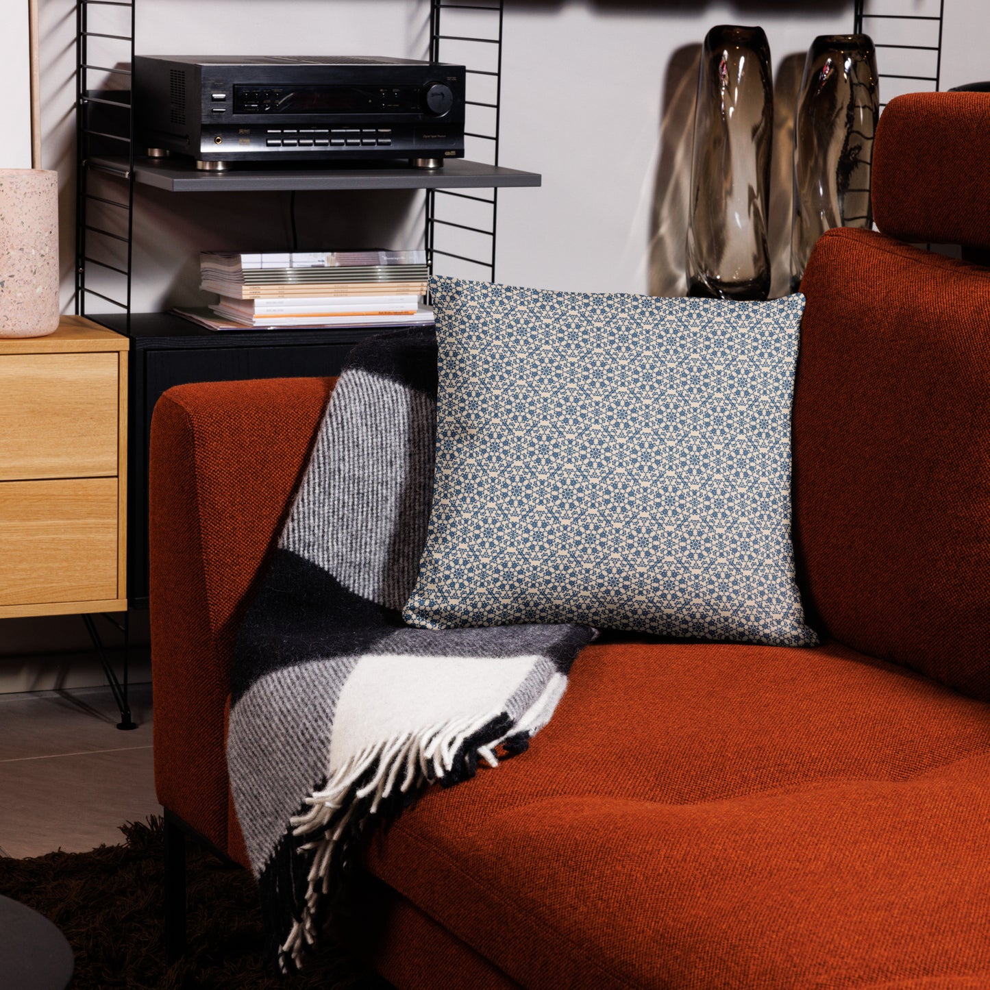 18″×18″ throw pillow with the ‘Octagon’ navy and beige geometric pattern on an armchair.