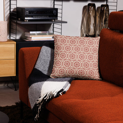 18″×18″ throw pillow with the ‘Decagon’ terracotta and beige geometric pattern on a terracotta sofa with a black and white throw.