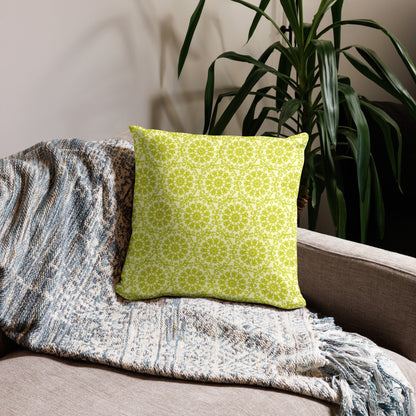 18″×18″ throw pillow with the 'Hendecagon' yellow-green geometric pattern on a beige sofa with woven throw