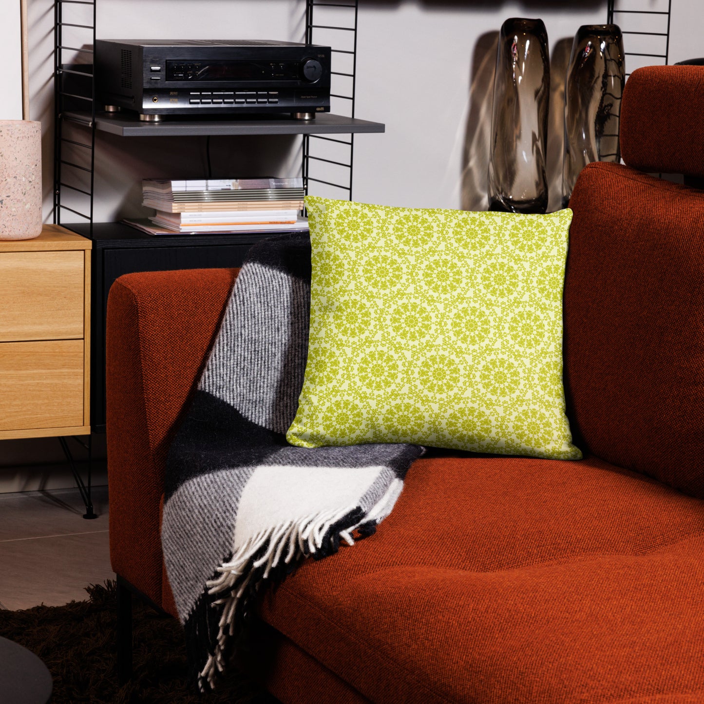 18″×18″ throw pillow with the 'Hendecagon' yellow-green geometric pattern on a terracotta sofa in a modern living room