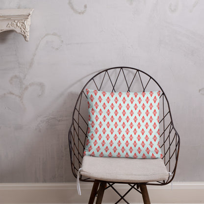 18″×18″ throw pillow with the 'Digon' sky blue and red geometric pattern on a chair.