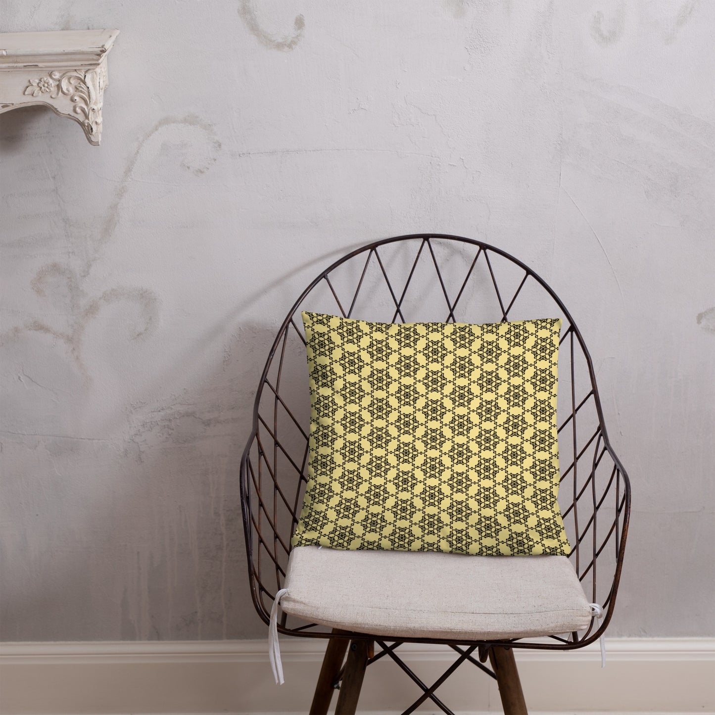 18″×18″ throw pillow with the 'Hexagon' yellow and black geometric pattern on a chair.