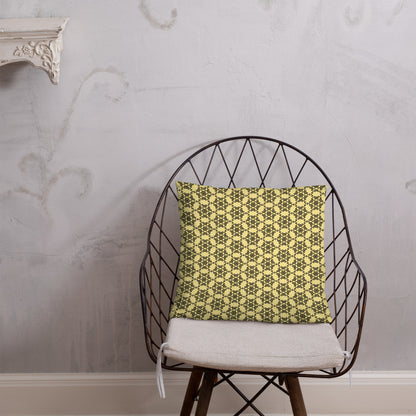 18″×18″ throw pillow with the 'Hexagon' yellow and black geometric pattern on a chair.