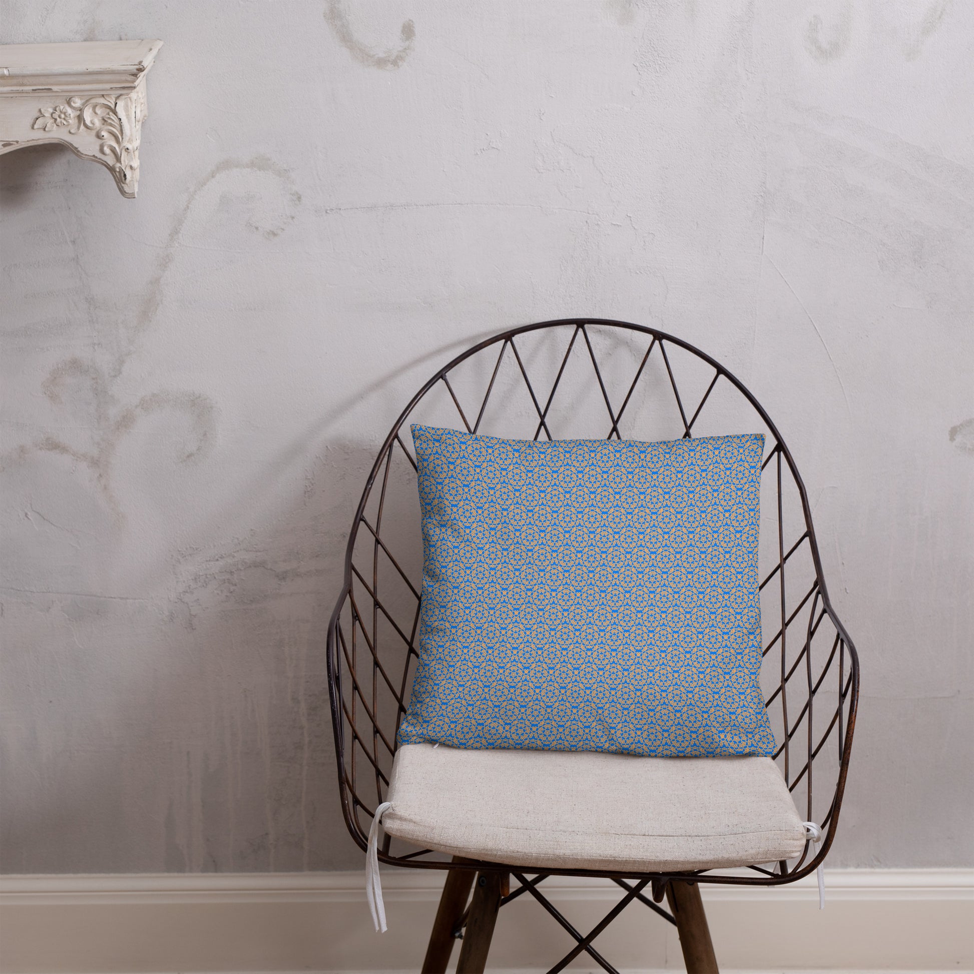 18″×18″ throw pillow with the 'Pentagon' blue and yellow geometric pattern on a chair.