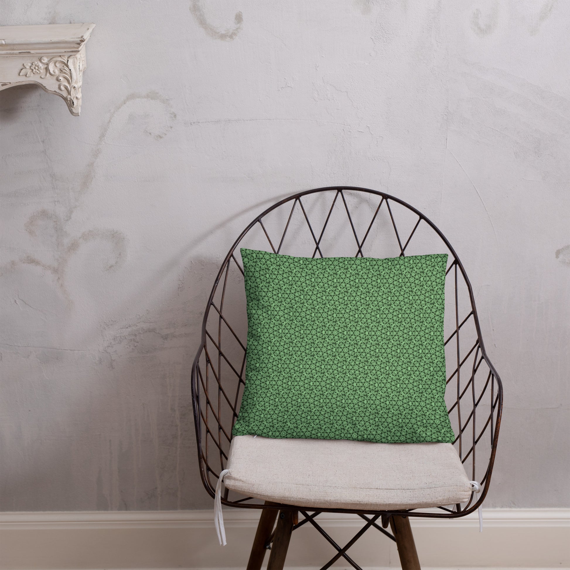 18″×18″ throw pillow with the 'Heptagon' green geometric pattern on a chair.