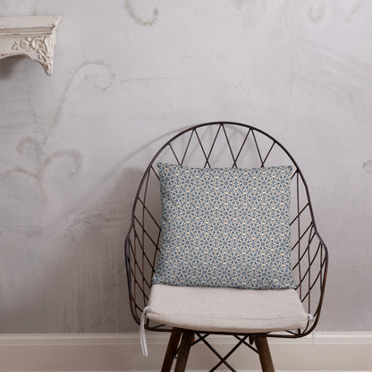 18″×18″ throw pillow with the ‘Octagon’ navy and beige geometric pattern on a wire chair.
