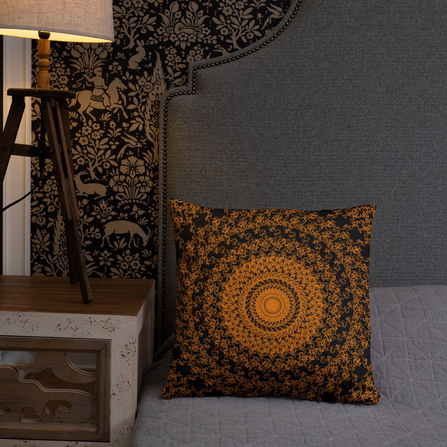18″×18″ throw pillow with the 'The Sun' orange and black geometric design on a bed.