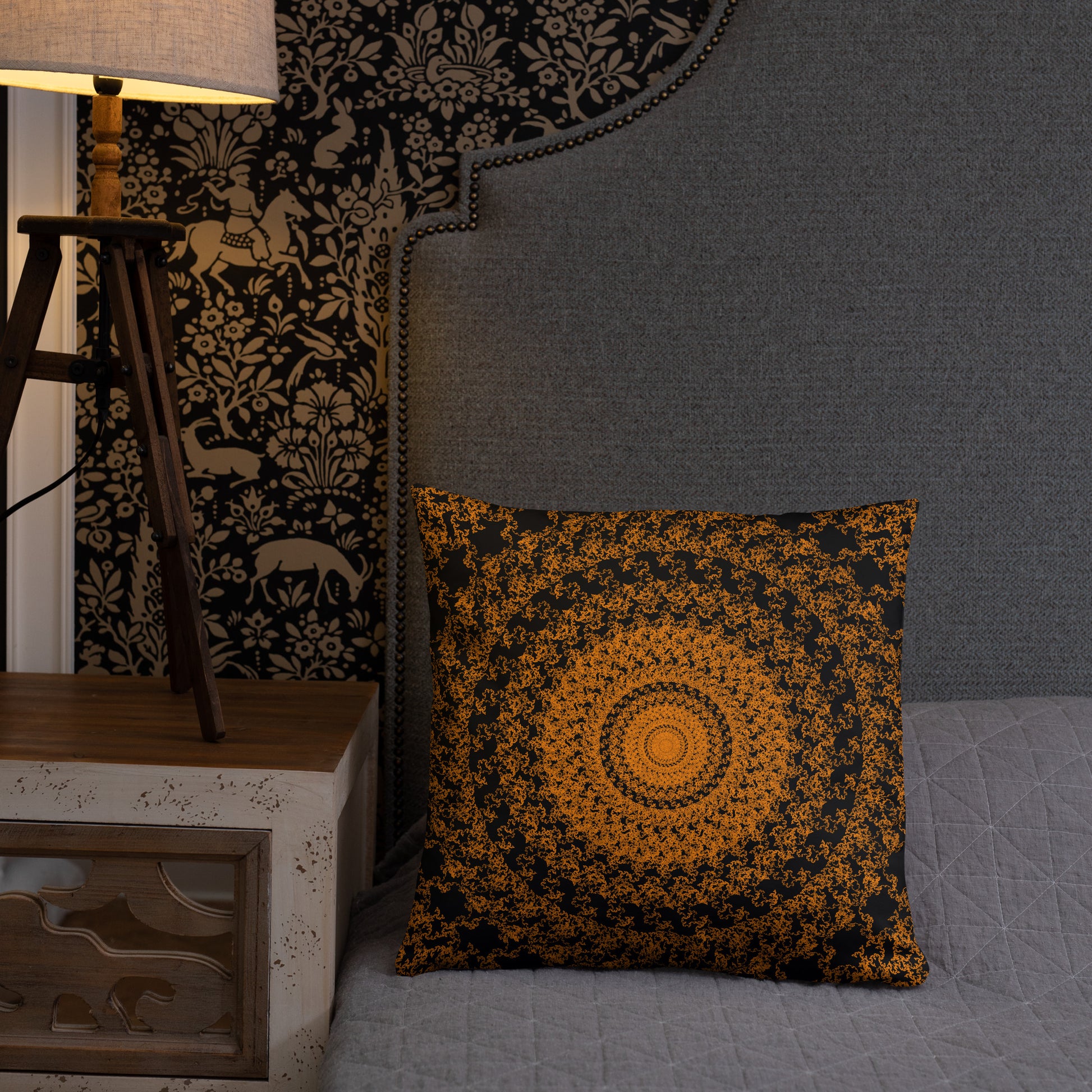 18″×18″ throw pillow with the 'The Sun' orange and black geometric design on a bed.