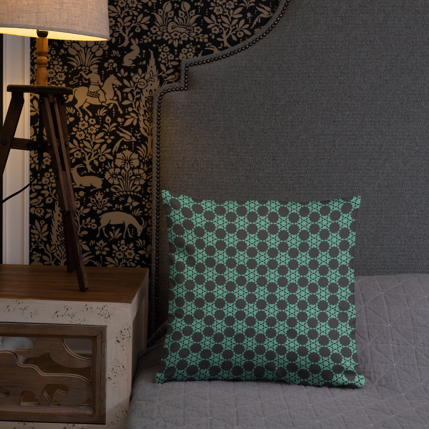 18″×18″ throw pillow with the 'Flowers Victory' charcoal and mint geometric pattern on a bed.