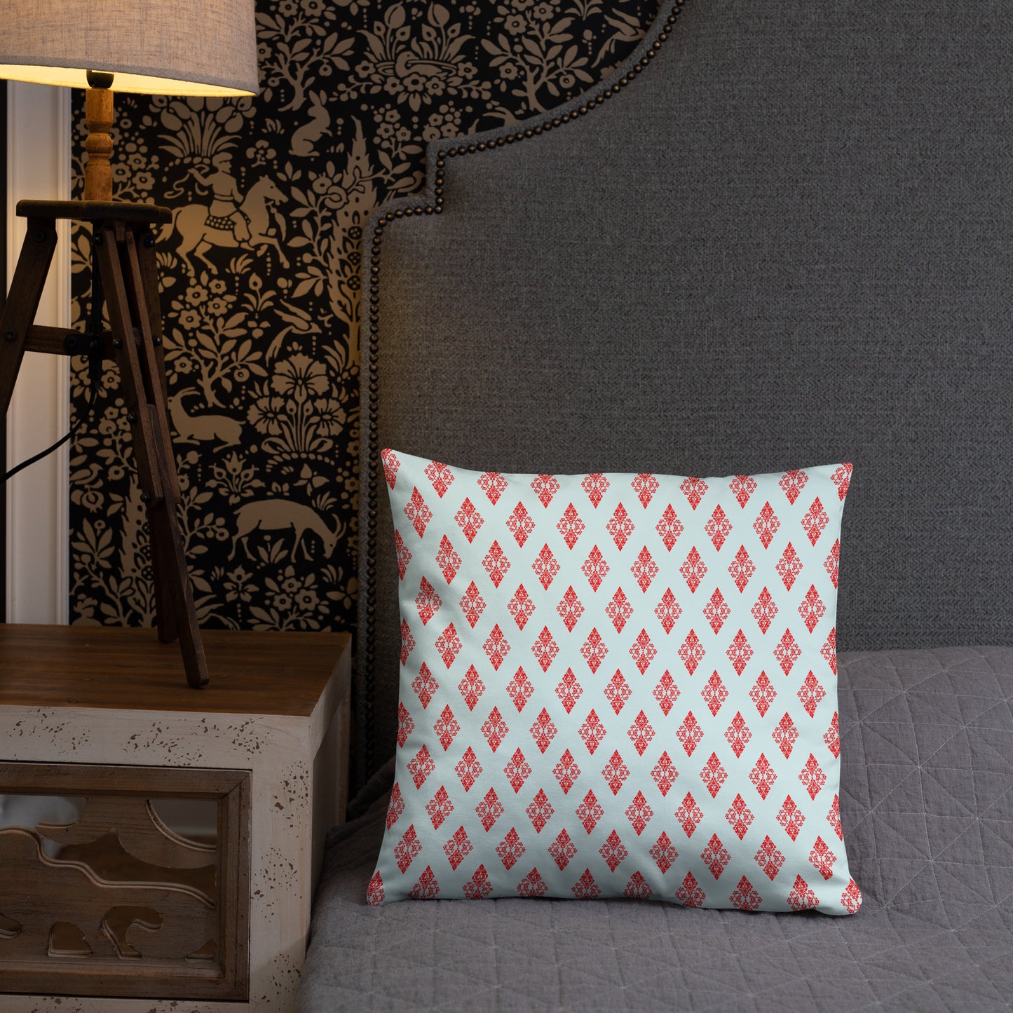 18″×18″ throw pillow with the 'Digon' sky blue and red geometric pattern on a bed.